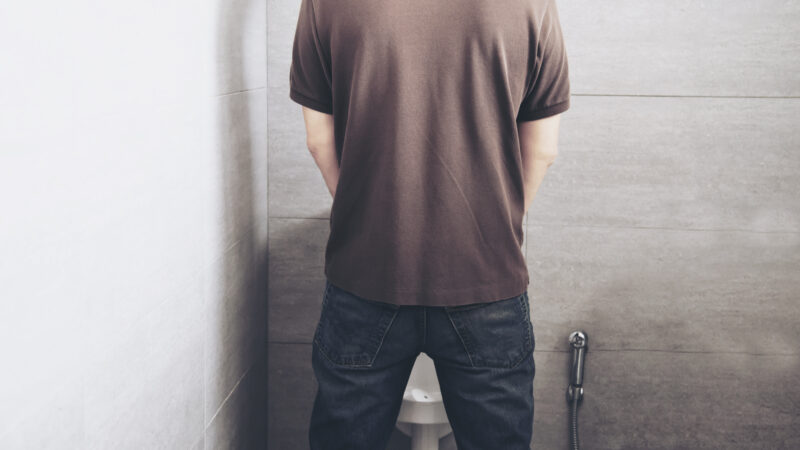 Man feeling discomfort due to difficulty urinating