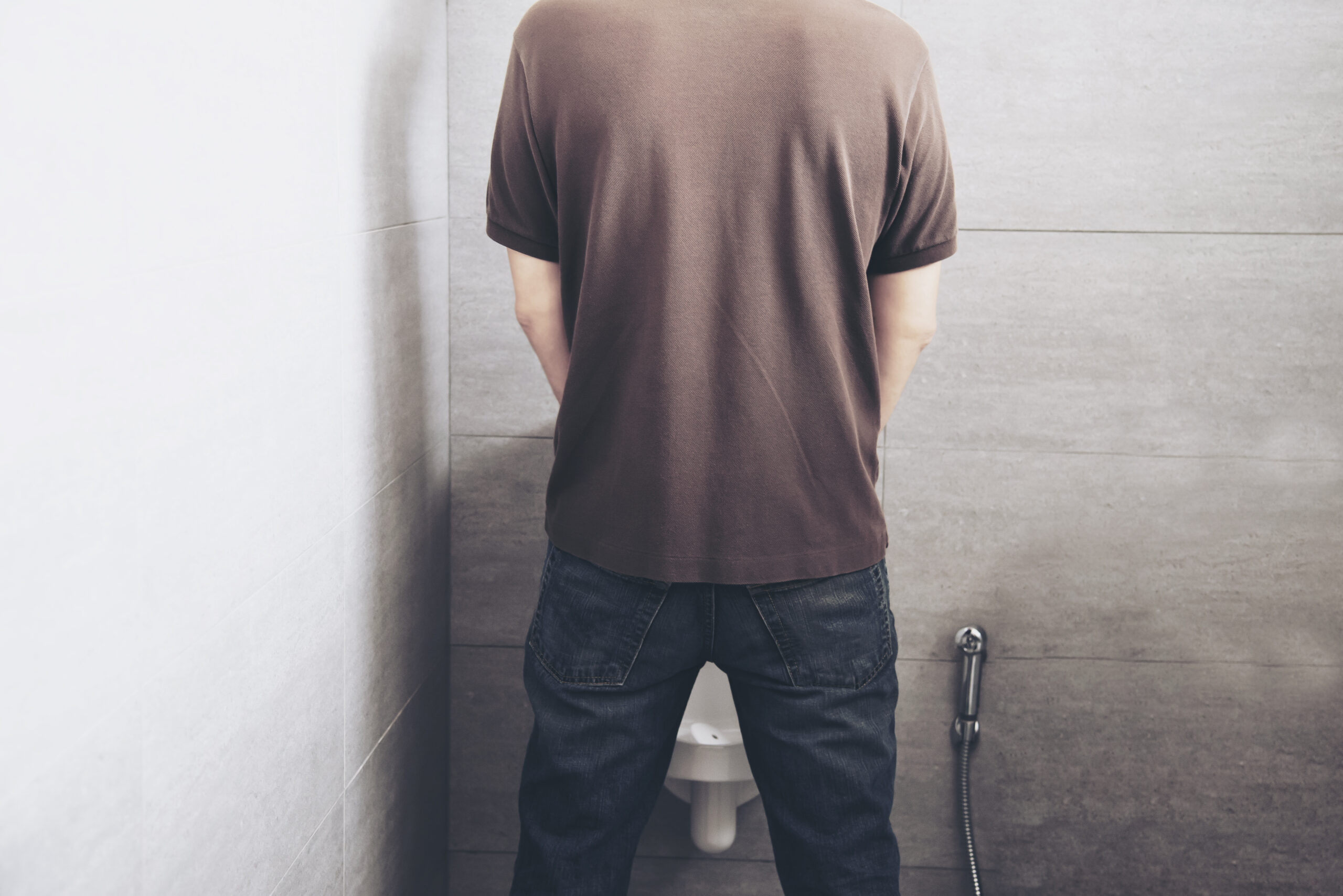 Man feeling discomfort due to difficulty urinating