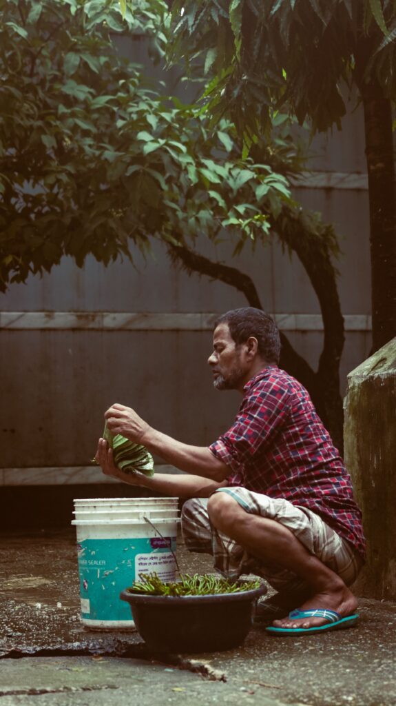 Man squatting during a daily activity for an article about knee pain when squatting