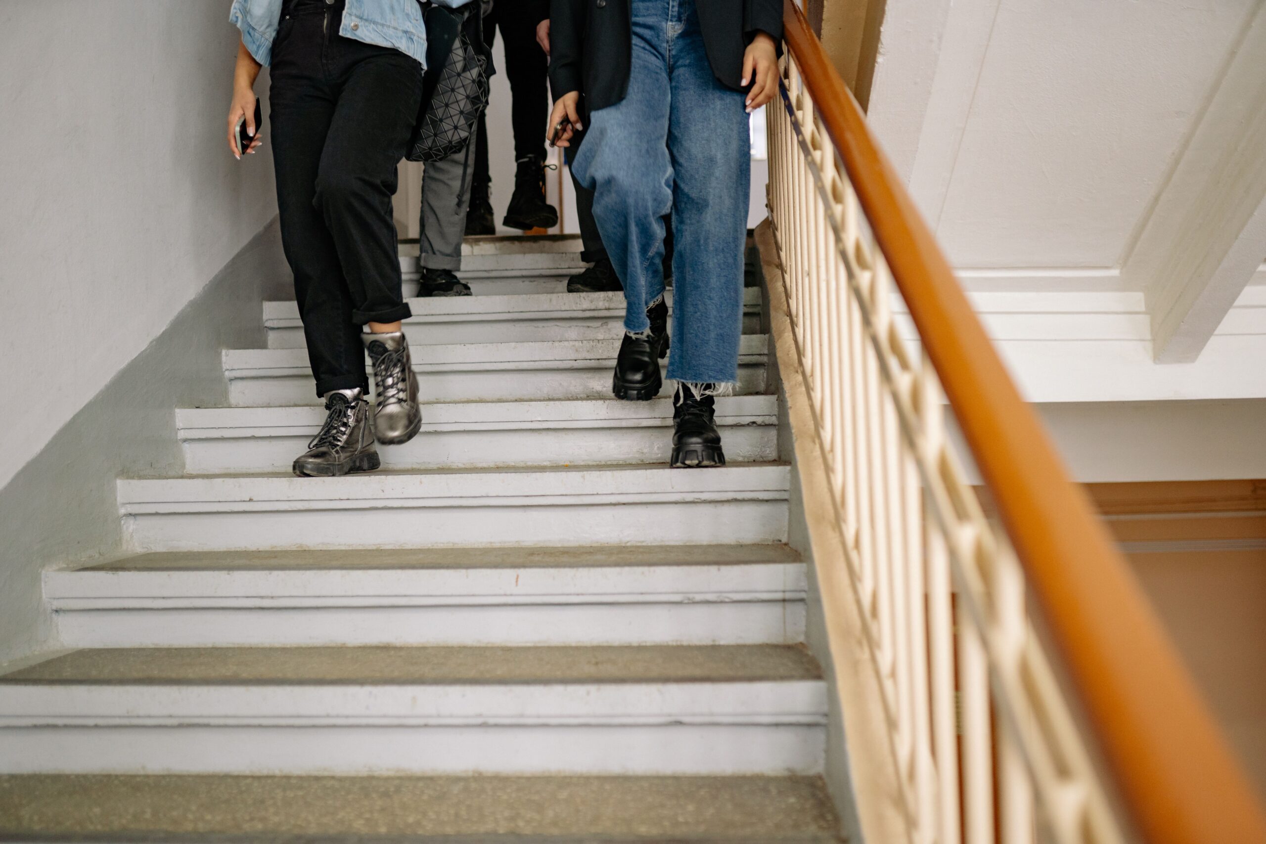 People walking down stairs for an article about knee pain on stairs by Relive Physiotherapy Petaling Jaya